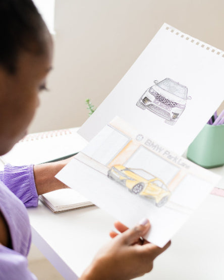 Person sitting at a desk with art supplies and a calendar in the background