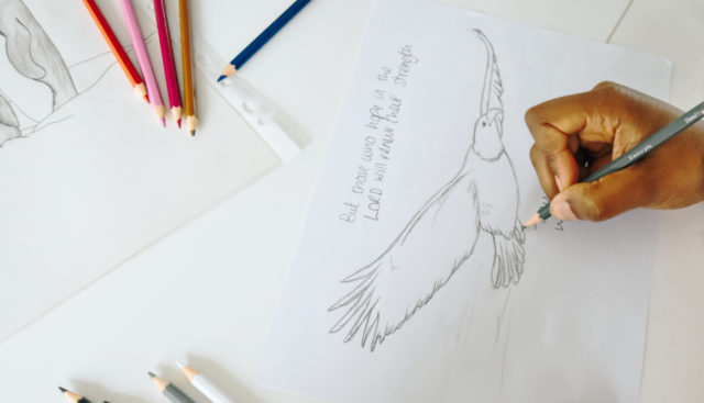 Lady hand drawing an eagle with a bible verse for custom designed corporate greeting cards for bulk business orders