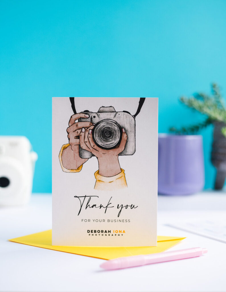 A business thank you card for a photography company featuring an illustration of a camera and a customised company logo. Thank you for choosing us card.