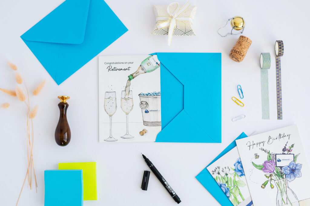 A customised company greeting card of a retirement card for colleague featuring a champagne bottle pouring into a glass and a personalised logo.