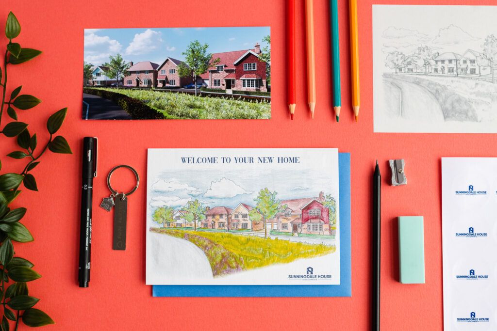 Corporate greeting card is a new home card. It features a row of houses. On the photo itself it shows the bespoke journey, with initial photo, hand illustration, and the finished card.